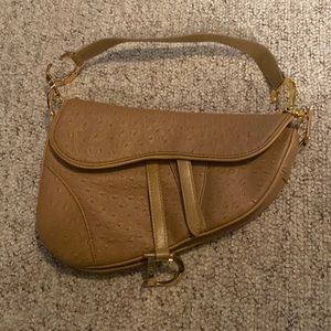 Knockoff horseshoe shaped purse “CD”